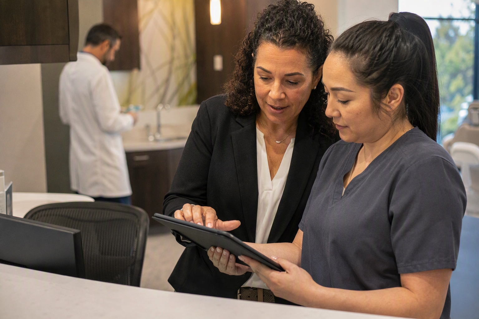 Depict a structured vendor-review workshop in a multi-location dental group’s conference room